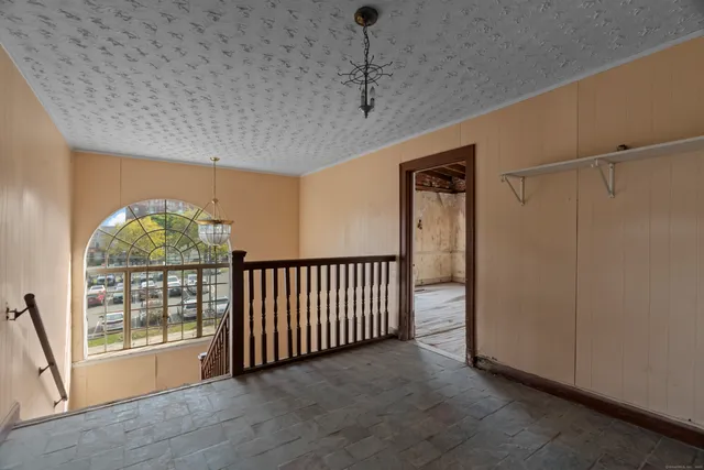 a view of a hallway with wooden shelves
