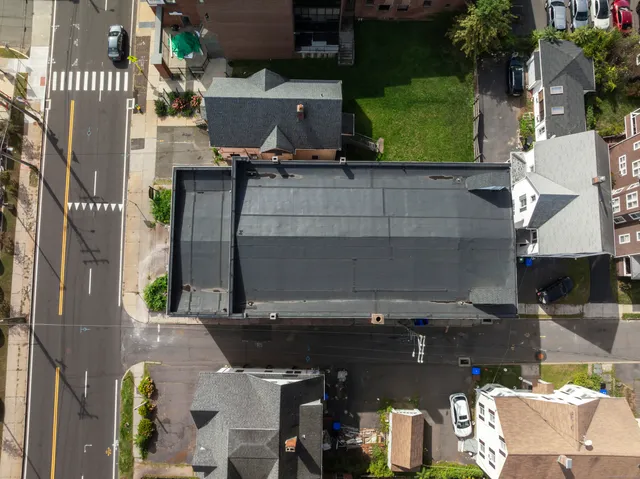 an aerial view of a house with a garden and parking space