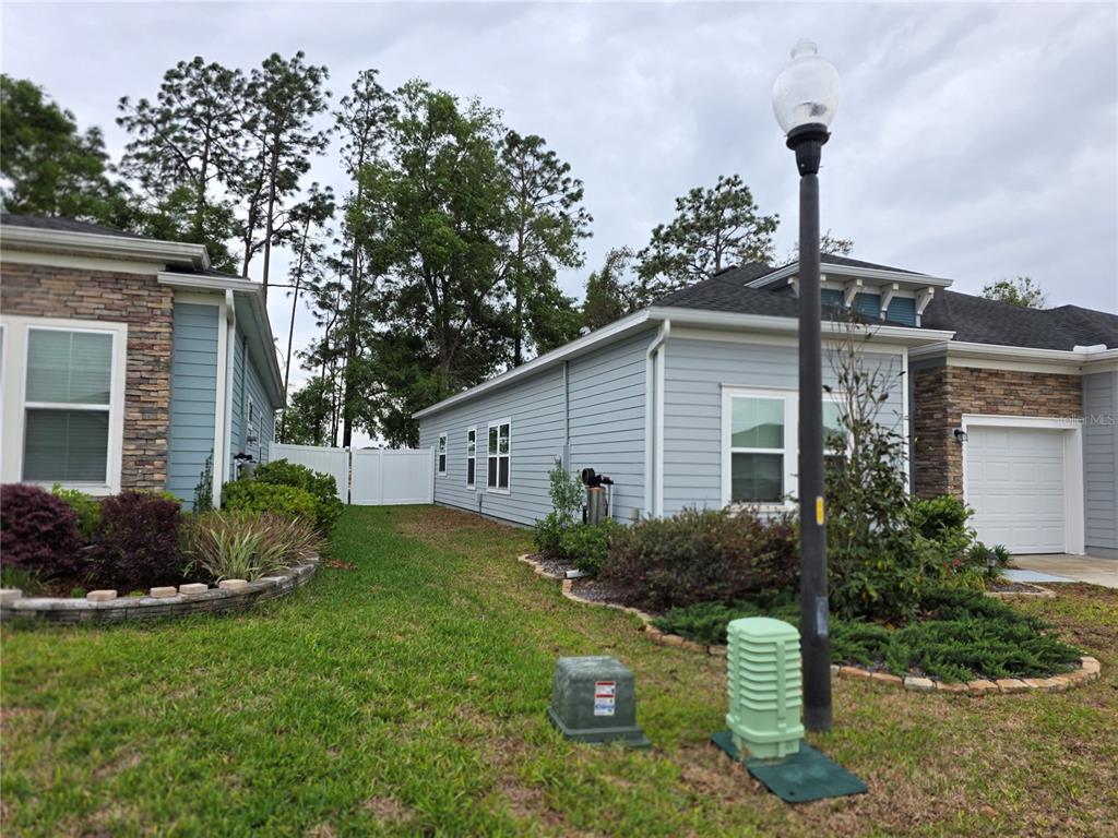 7875 Southwest 74th Street Ocala, FL 34474 - Photo 5 of 28 a front view of a house with garden