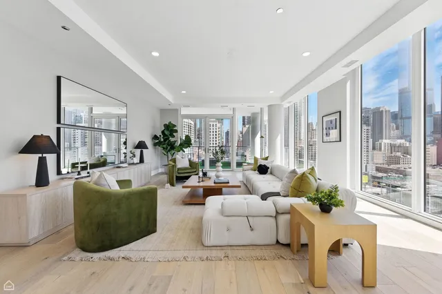 a living room with fireplace furniture and a large window