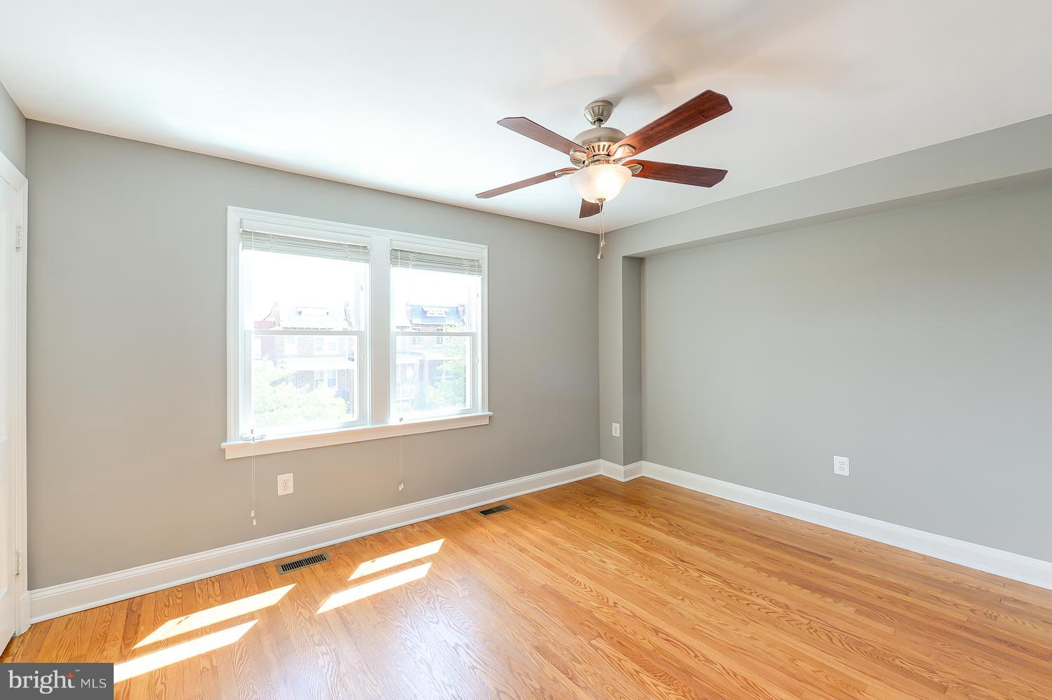 1334 Queen Street Northeast Washington, DC 20002 - Photo 12 of 29 a view of an empty room with wooden floor and a window