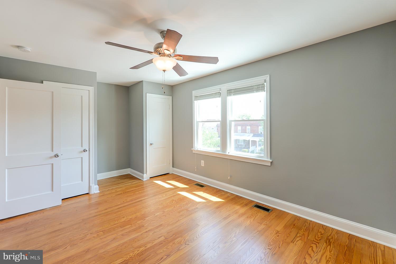 1334 Queen Street Northeast Washington, DC 20002 - Photo 13 of 29 a view of an empty room with window and wooden floor