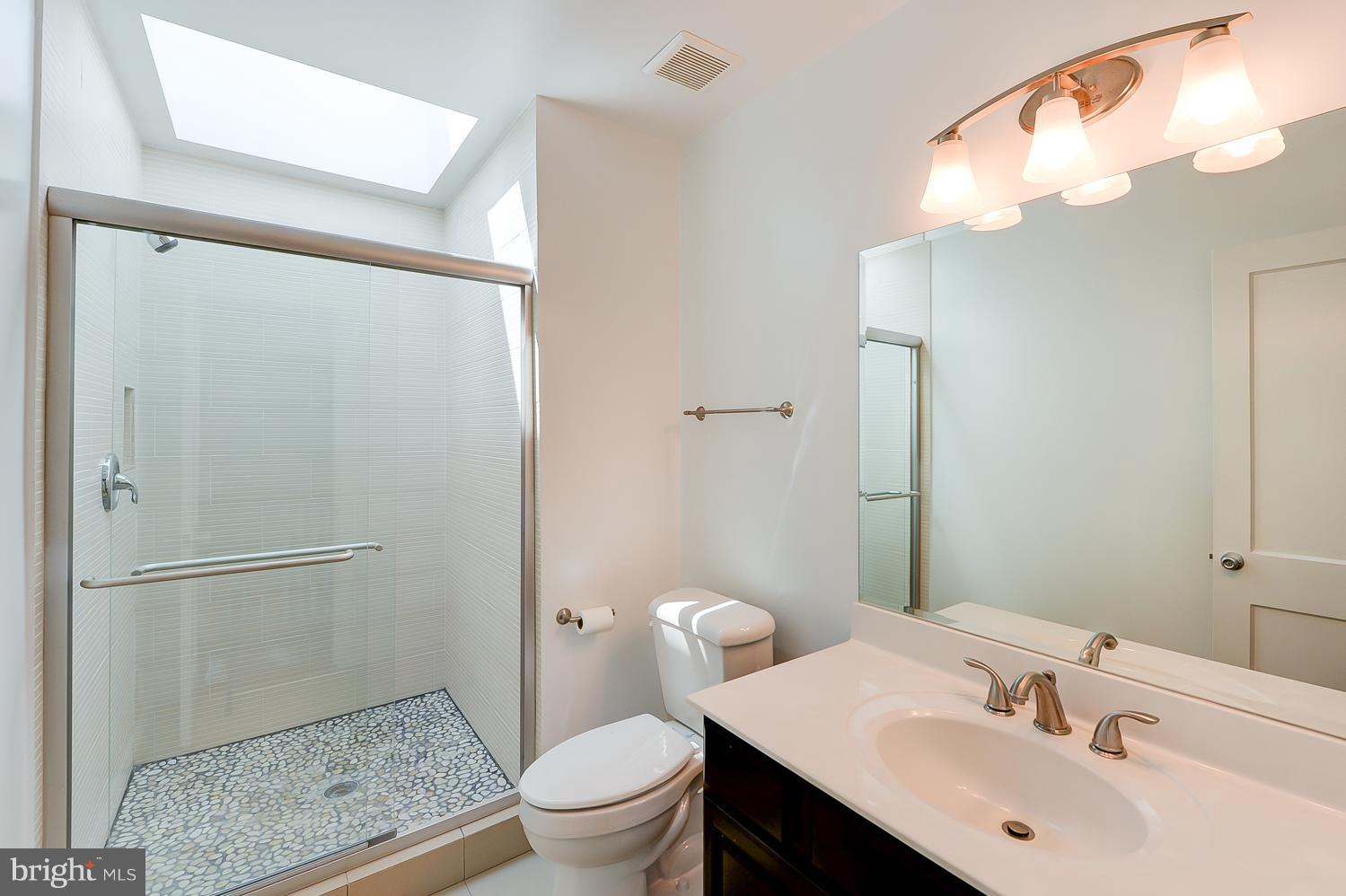 1334 Queen Street Northeast Washington, DC 20002 - Photo 15 of 29 a bathroom with a sink a toilet and shower