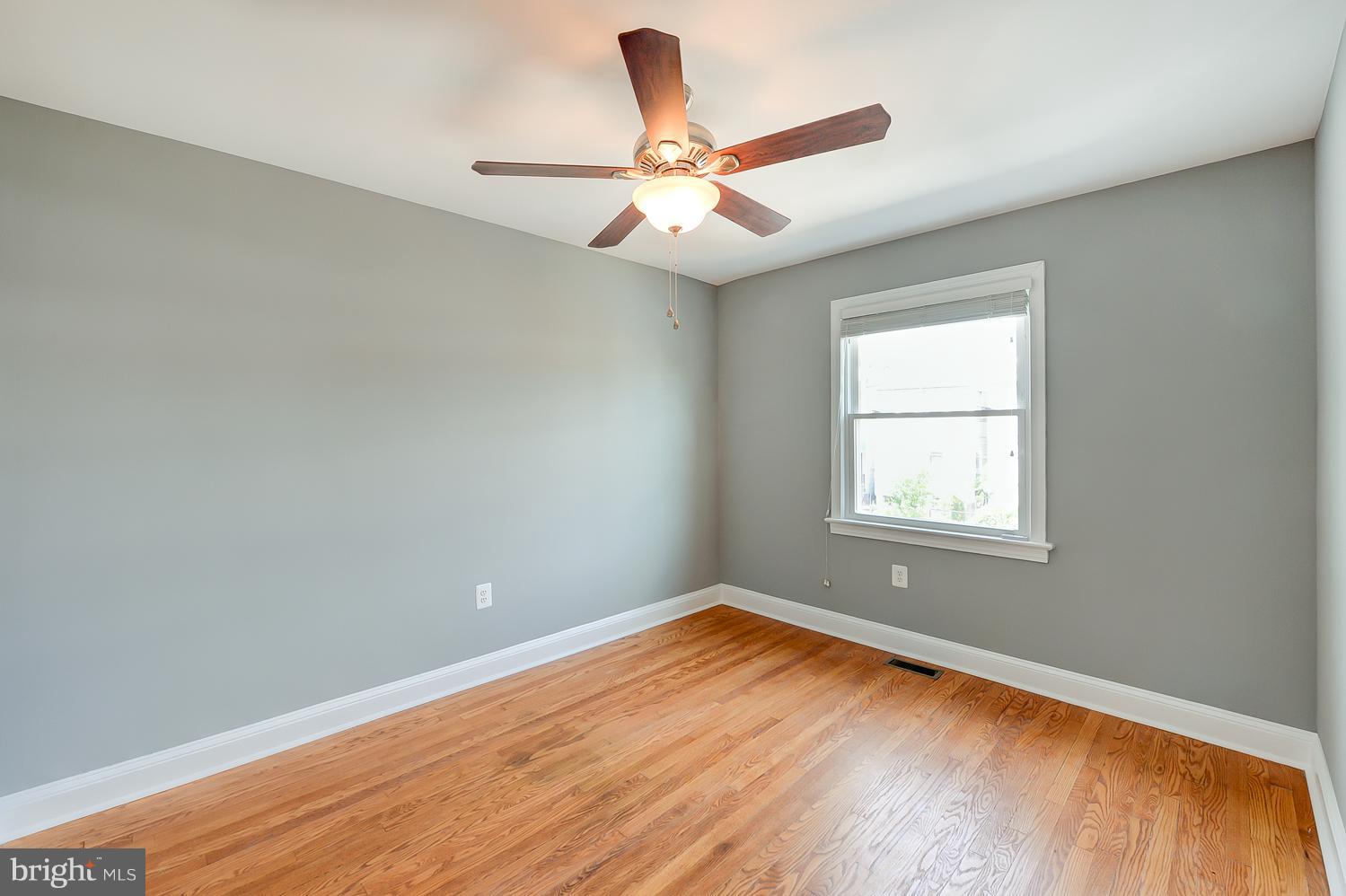 1334 Queen Street Northeast Washington, DC 20002 - Photo 17 of 29 wooden floor in an empty room with a window