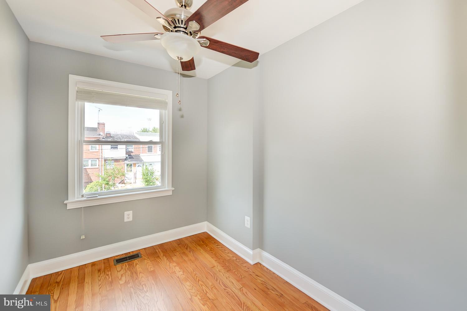 1334 Queen Street Northeast Washington, DC 20002 - Photo 20 of 29 an empty room with a window and wooden floor
