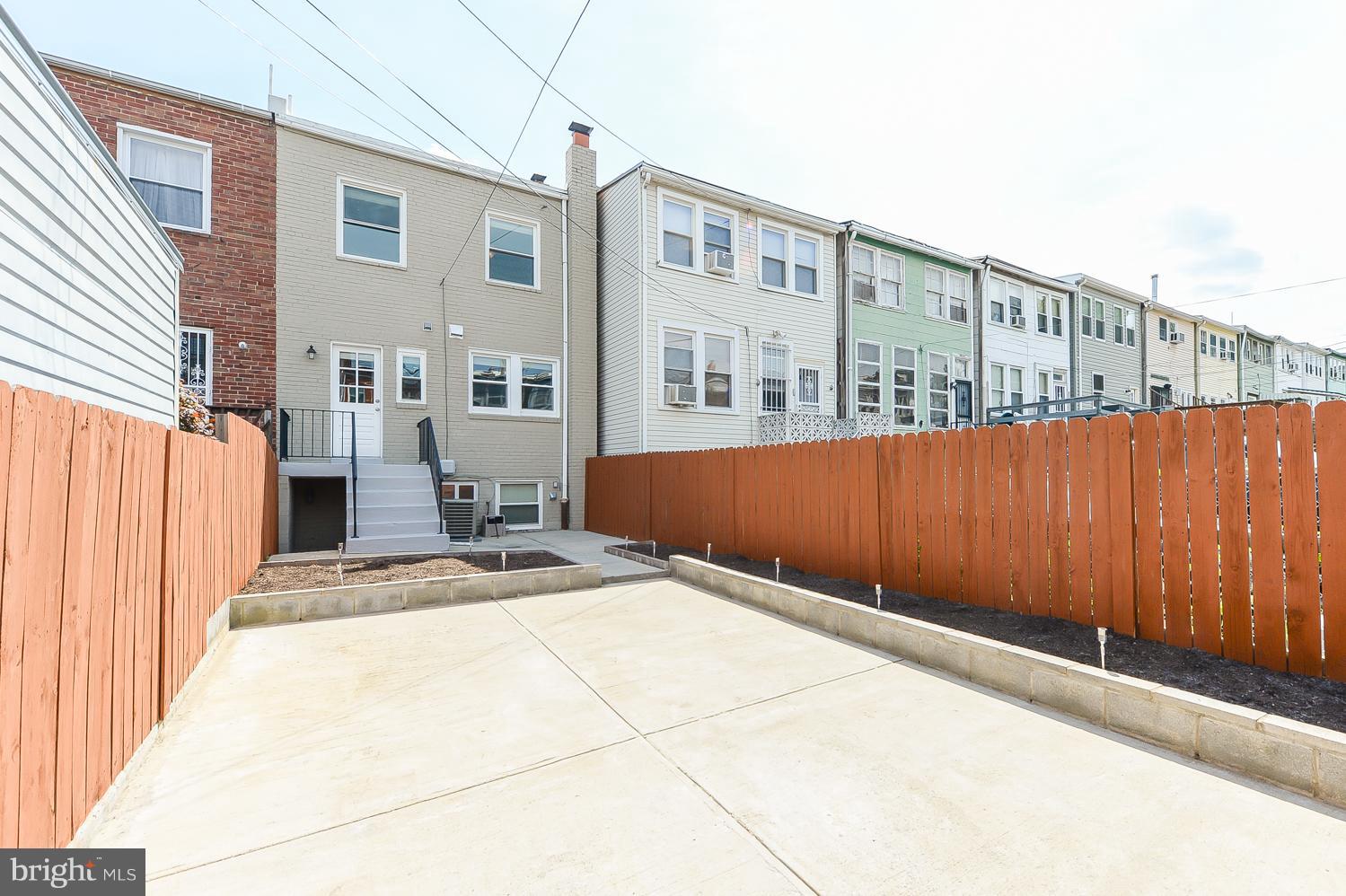 1334 Queen Street Northeast Washington, DC 20002 - Photo 24 of 29 a view of a blue house with wooden fence
