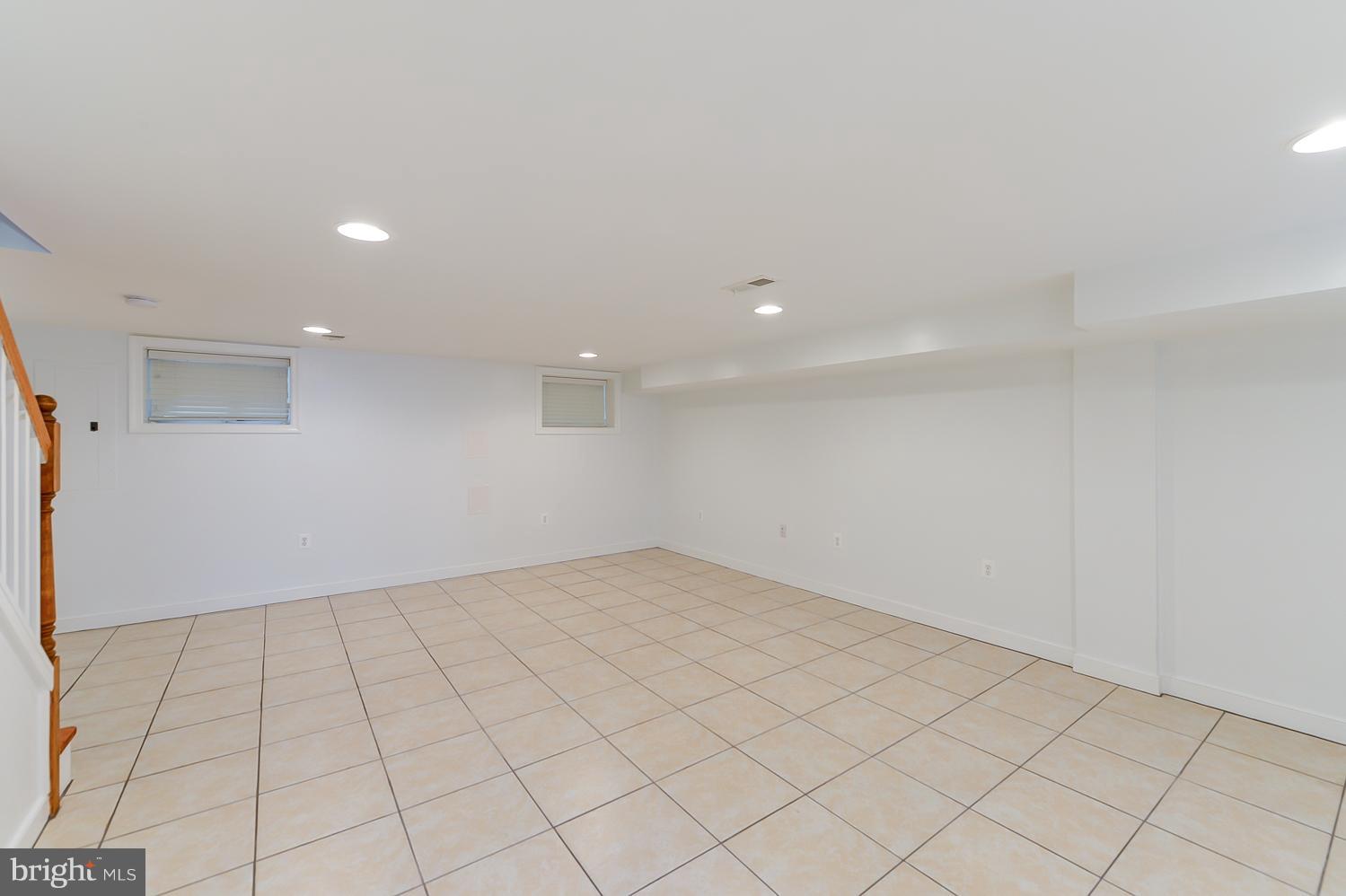 1334 Queen Street Northeast Washington, DC 20002 - Photo 28 of 29 an empty room with white walls and tiles