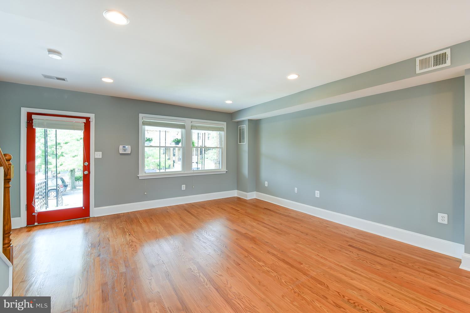 1334 Queen Street Northeast Washington, DC 20002 - Photo 5 of 29 an empty room with wooden floor and windows