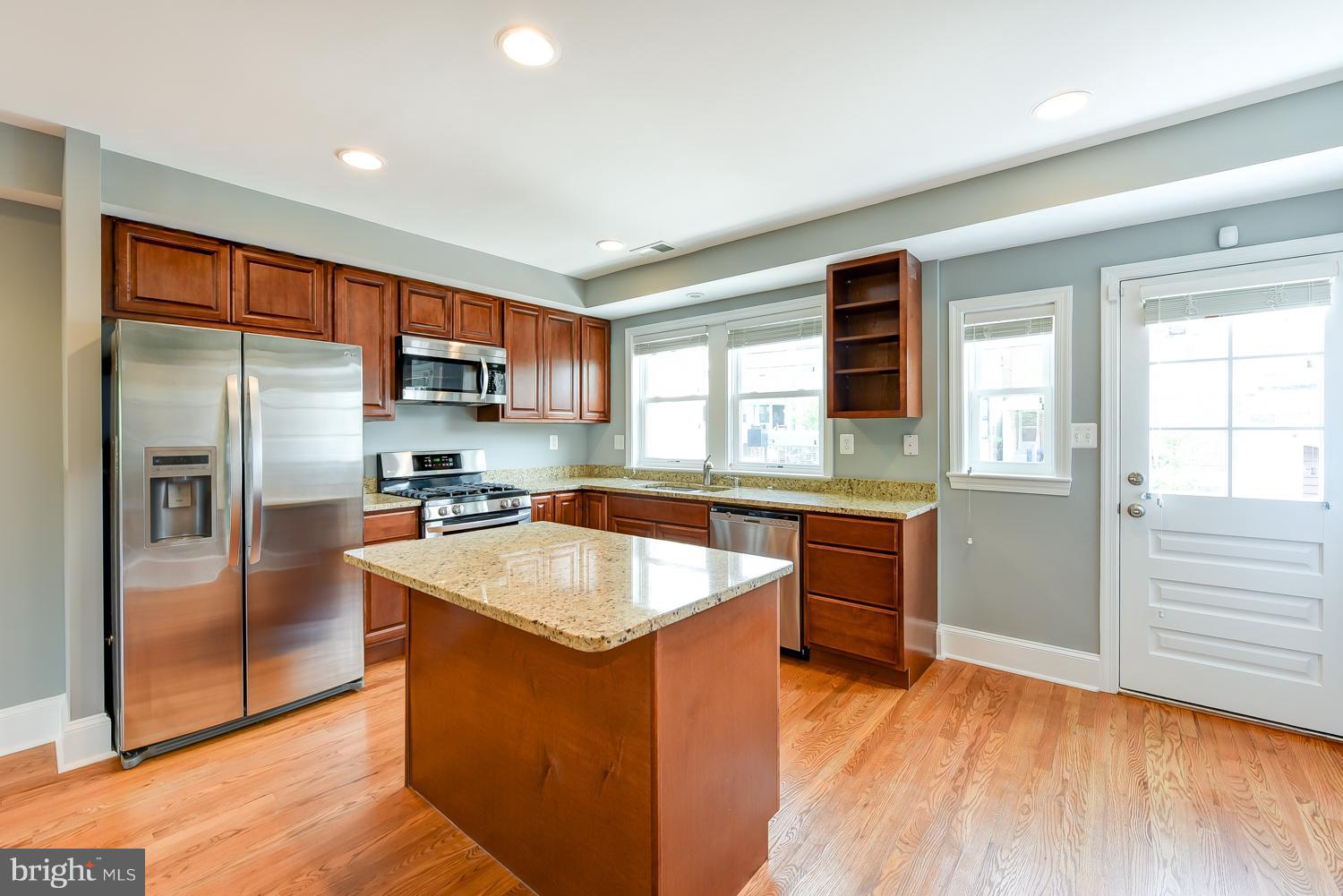 1334 Queen Street Northeast Washington, DC 20002 - Photo 8 of 29 a kitchen with stainless steel appliances granite countertop a refrigerator a sink a stove and oven