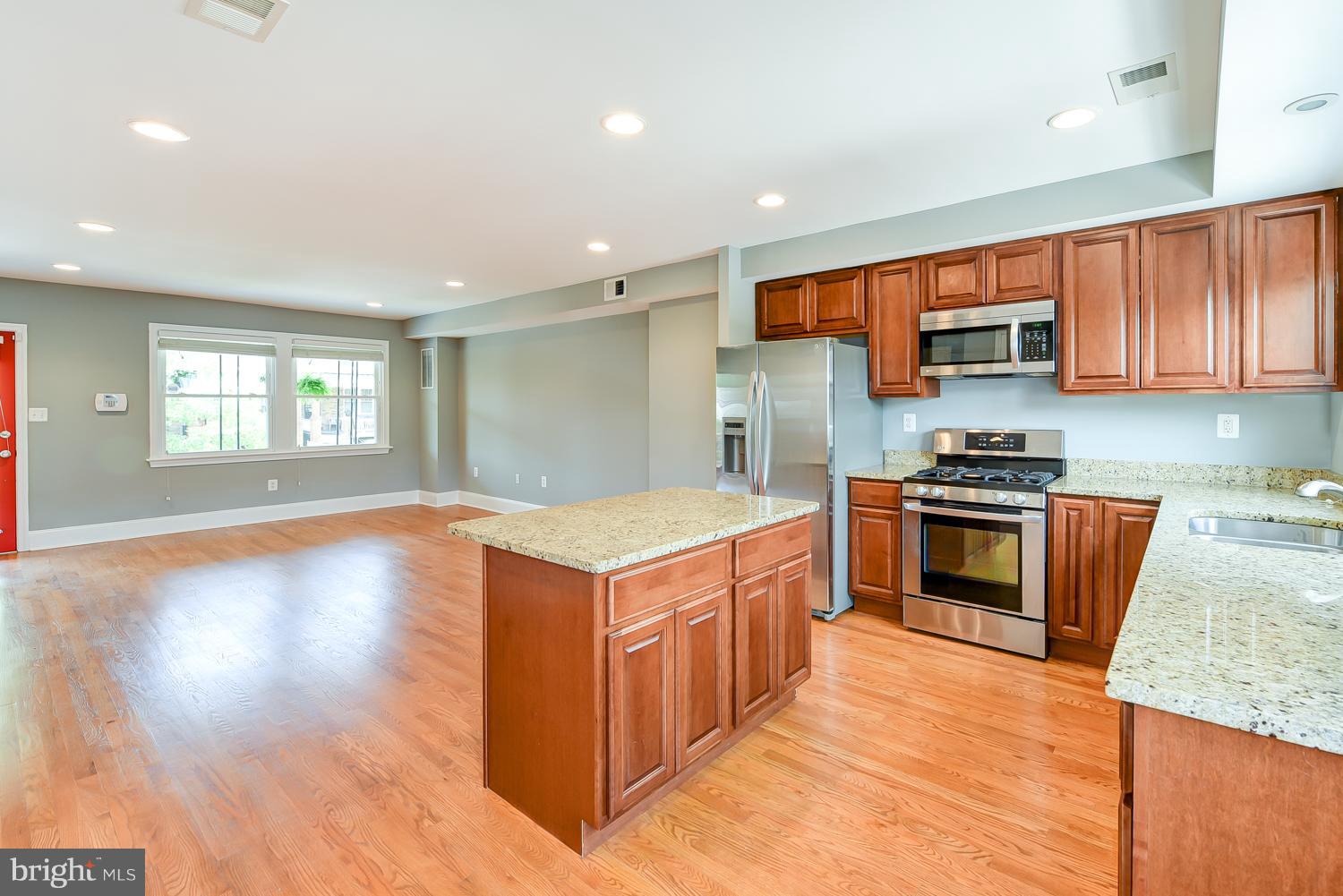 1334 Queen Street Northeast Washington, DC 20002 - Photo 10 of 29 a kitchen with stainless steel appliances granite countertop a stove a sink and a refrigerator