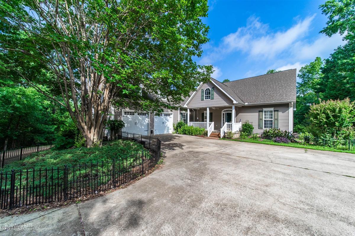 4271 Upper River Road Gray, GA 31032 - Photo 1 of 40 a front view of a house with a garden