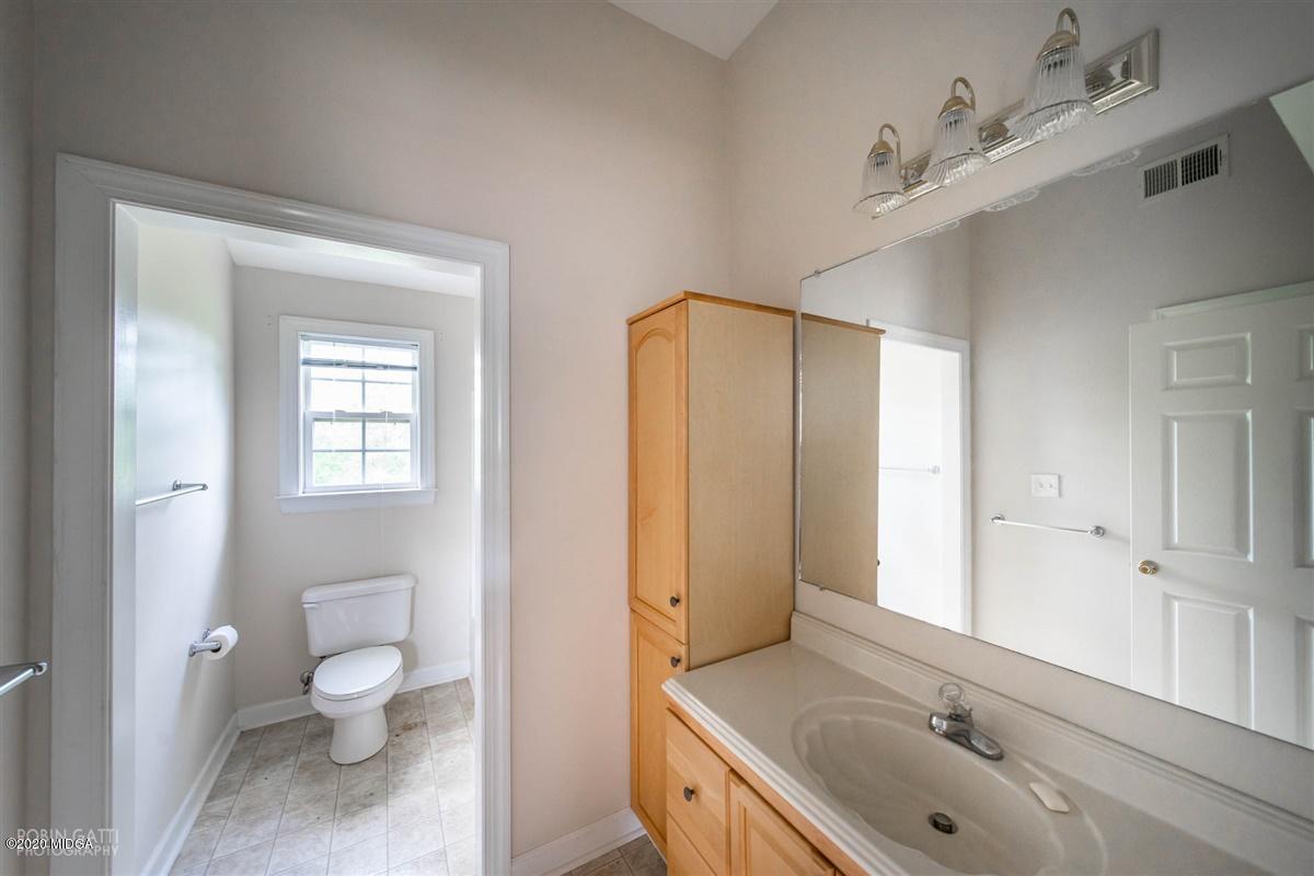 4271 Upper River Road Gray, GA 31032 - Photo 12 of 40 a bathroom with a granite countertop sink toilet and shower