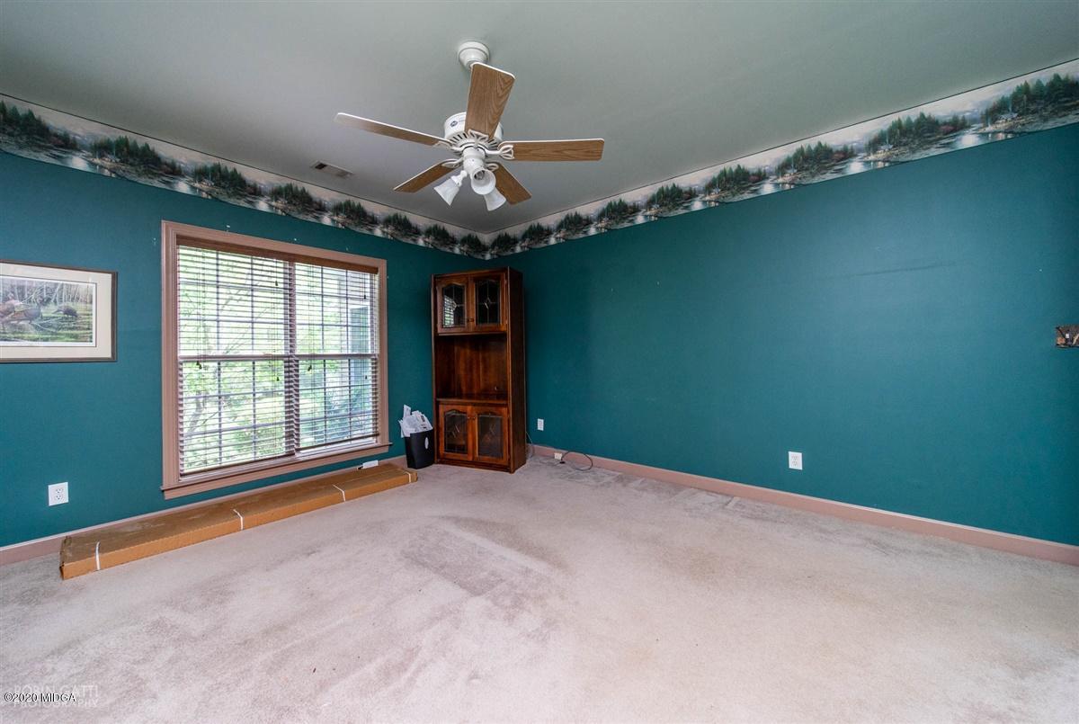 4271 Upper River Road Gray, GA 31032 - Photo 21 of 40 a view of a livingroom with a ceiling fan and window