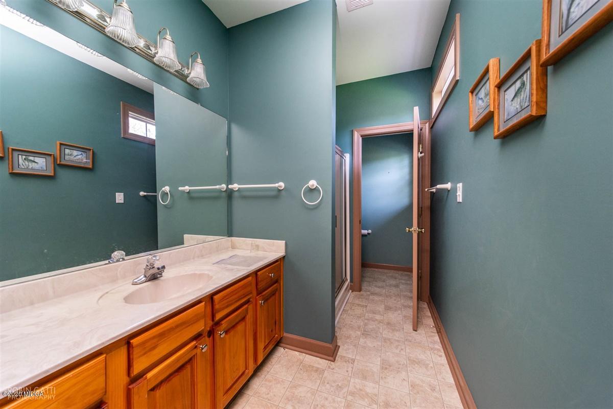 4271 Upper River Road Gray, GA 31032 - Photo 22 of 40 a bathroom with a sink and a mirror