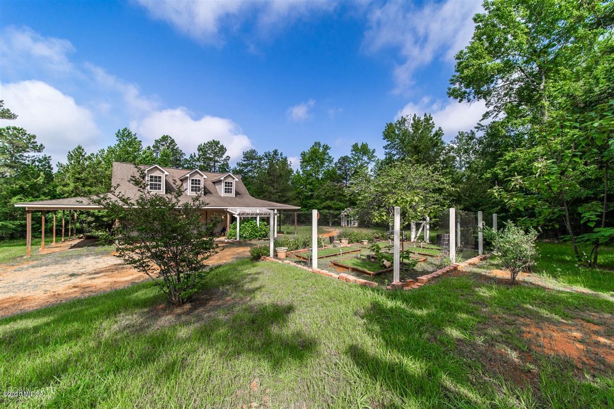 4271 Upper River Road Gray, GA 31032 - Photo 29 of 40 a view of a chair and tables in the garden