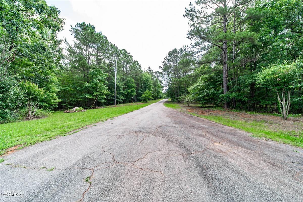4271 Upper River Road Gray, GA 31032 - Photo 32 of 40 a view of a yard with potted plants and large trees