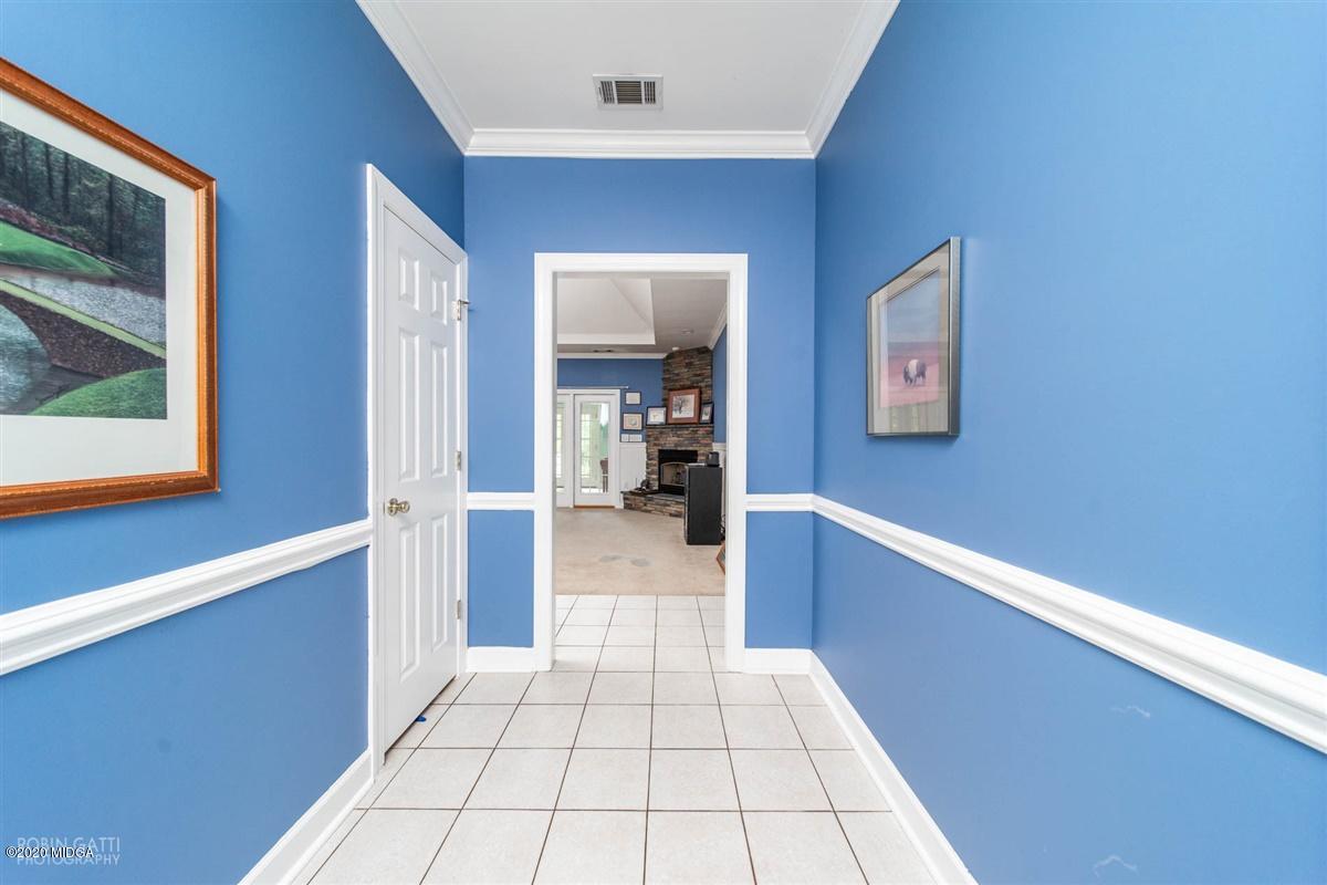 4271 Upper River Road Gray, GA 31032 - Photo 5 of 40 a hallway with a large mirror and a window