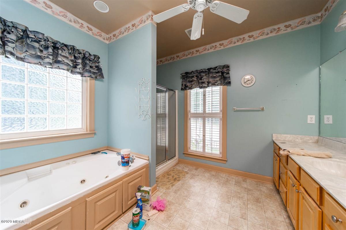 4271 Upper River Road Gray, GA 31032 - Photo 8 of 40 a bathroom with a tub sink and mirror