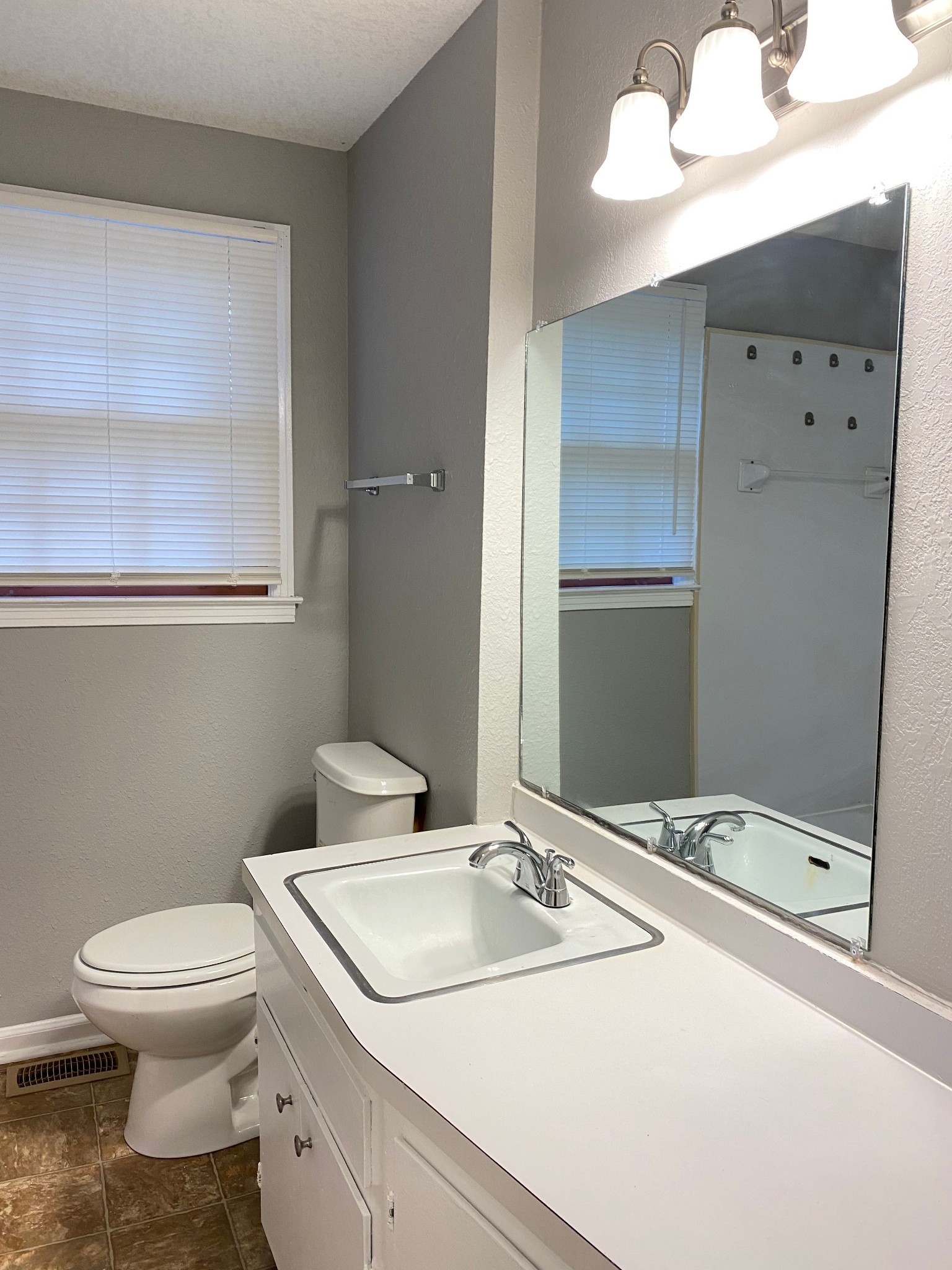 222 North 11th Street Clarksville, TN 37040 - Photo 11 of 14 a bathroom with a sink toilet and mirror