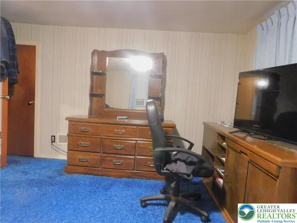 a room with gym equipment and view of living room