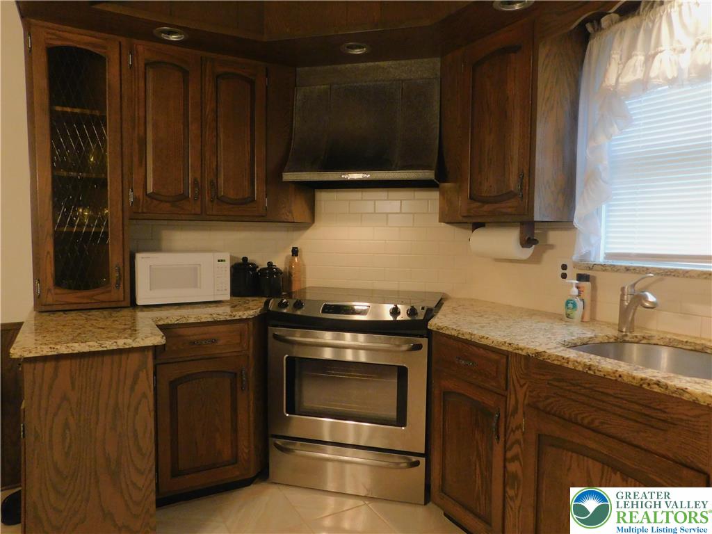 3023 Middletown Road Bethlehem, PA 18020 - Photo 9 of 28 a kitchen with granite countertop wood cabinets and stainless steel appliances