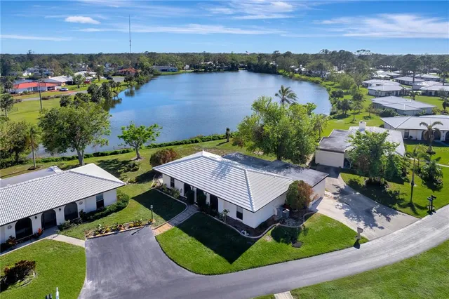 an aerial view of a house with outdoor space and lake view