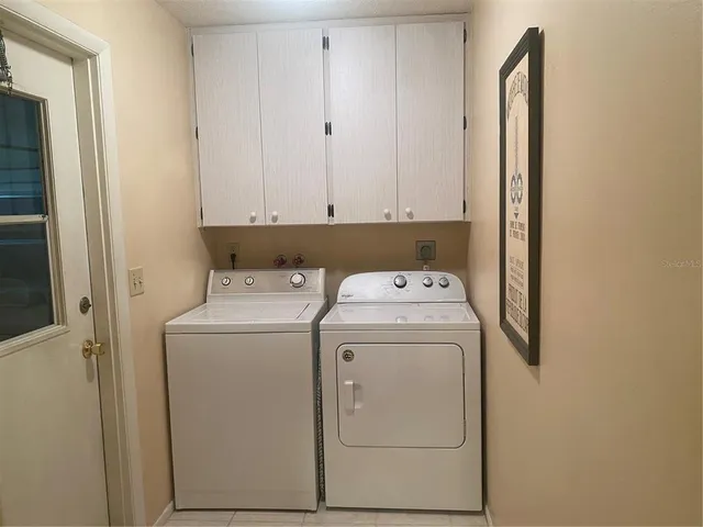 a kitchen with a refrigerator sink and cabinets