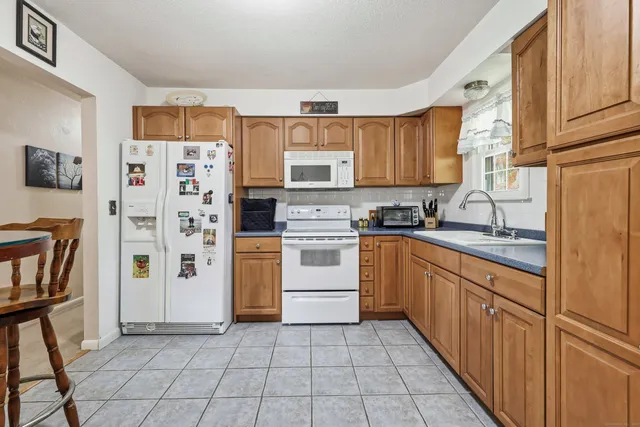 a kitchen with stainless steel appliances a refrigerator sink and cabinets