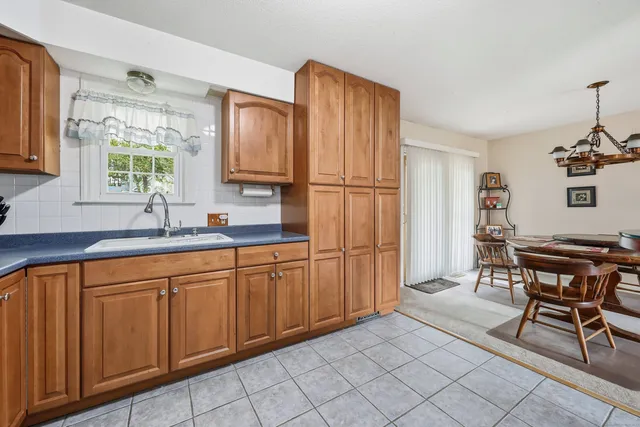 a kitchen with cabinets and chairs