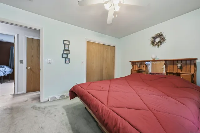 a bedroom with a large bed and a chandelier