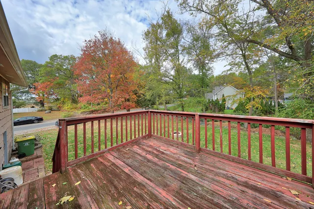 a balcony with wooden floor and fence