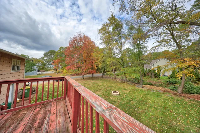 a view of balcony with wooden floor and fence