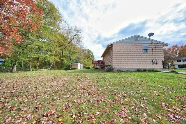 a backyard of a house with table and chairs