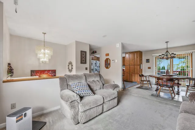 a living room with furniture and a chandelier