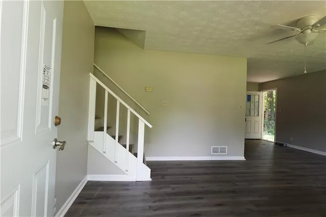 a view of an entryway with wooden floor