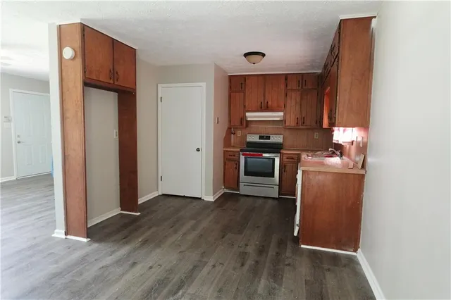 a view of a kitchen with a sink and a refrigerator