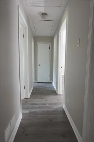a view of hallway with wooden floor