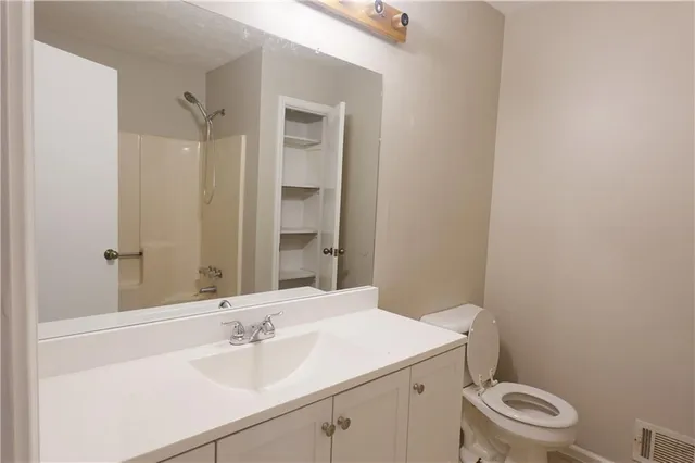 a bathroom with a sink toilet and vanity
