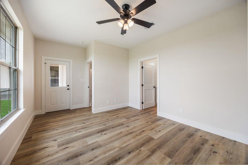 120 Quail Run Court Decatur, TX 76234 - Photo 24 of 34 Guest bedroom with the door to the back patio