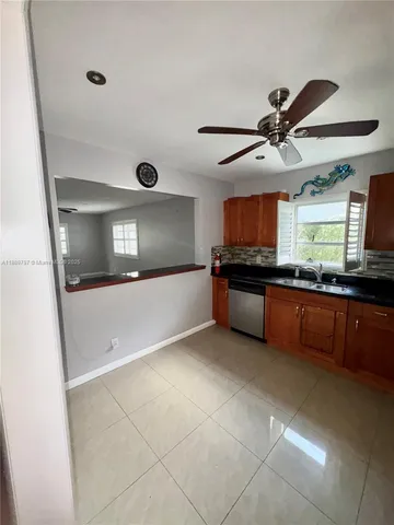 a kitchen with granite countertop a stove and a sink