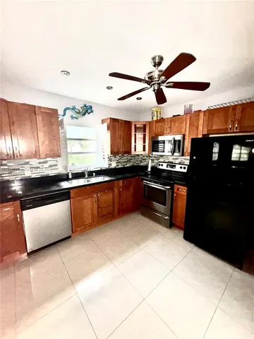 a kitchen with stainless steel appliances granite countertop a sink and a counter