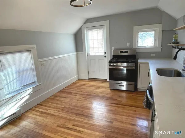 a kitchen with granite countertop a stove and a refrigerator