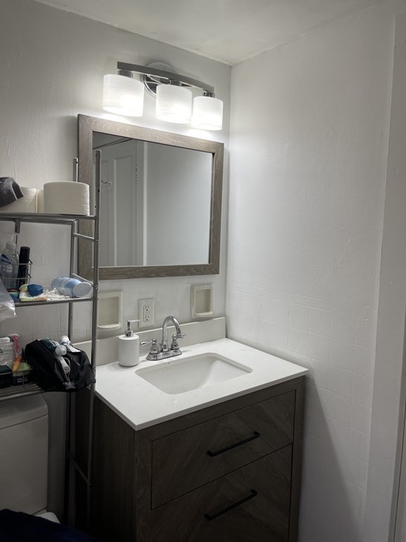 10 Eddy Street Ware, MA 01082 - Photo 11 of 20 a bathroom with a sink vanity and mirror