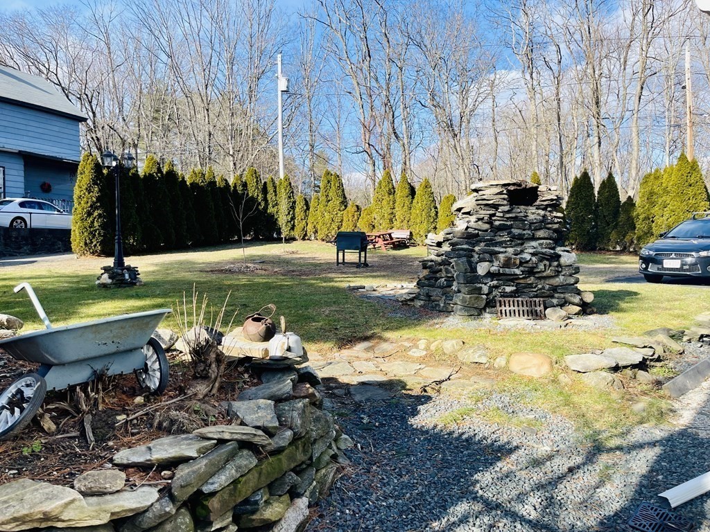 10 Eddy Street Ware, MA 01082 - Photo 4 of 20 a view of a swimming pool with lawn chairs under an umbrella