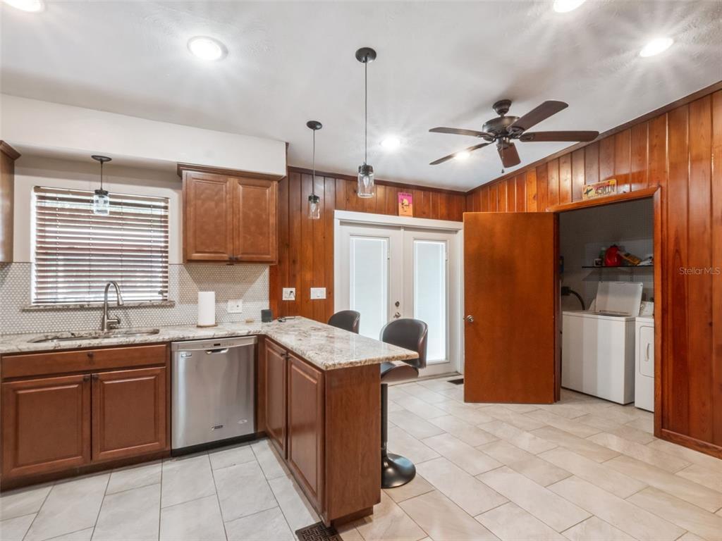 2819 Rogan Road Orlando, FL 32812 - Photo 12 of 28 a kitchen with a sink stove and cabinets