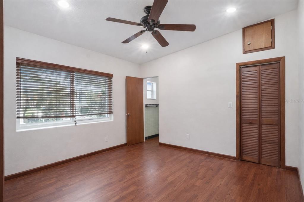 2819 Rogan Road Orlando, FL 32812 - Photo 14 of 28 a view of an empty room with a window and wooden floor