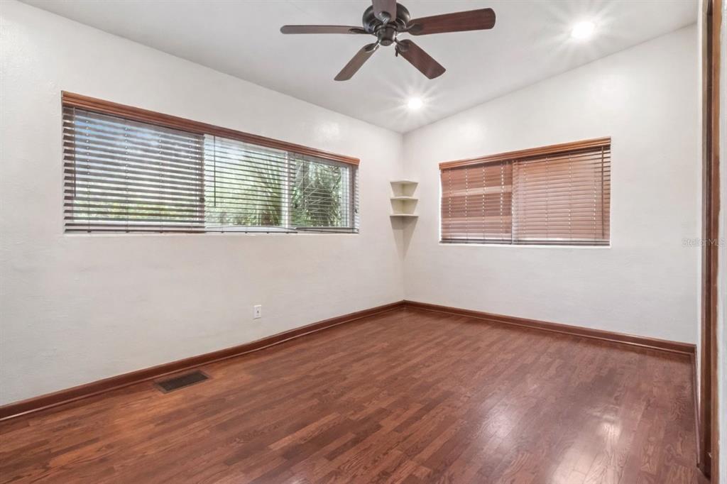 2819 Rogan Road Orlando, FL 32812 - Photo 15 of 28 a view of an empty room with wooden floor and a window
