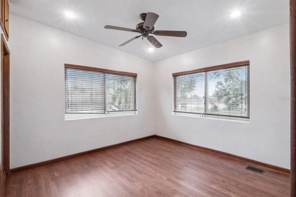2819 Rogan Road Orlando, FL 32812 - Photo 16 of 28 a view of an empty room with a window and wooden floor