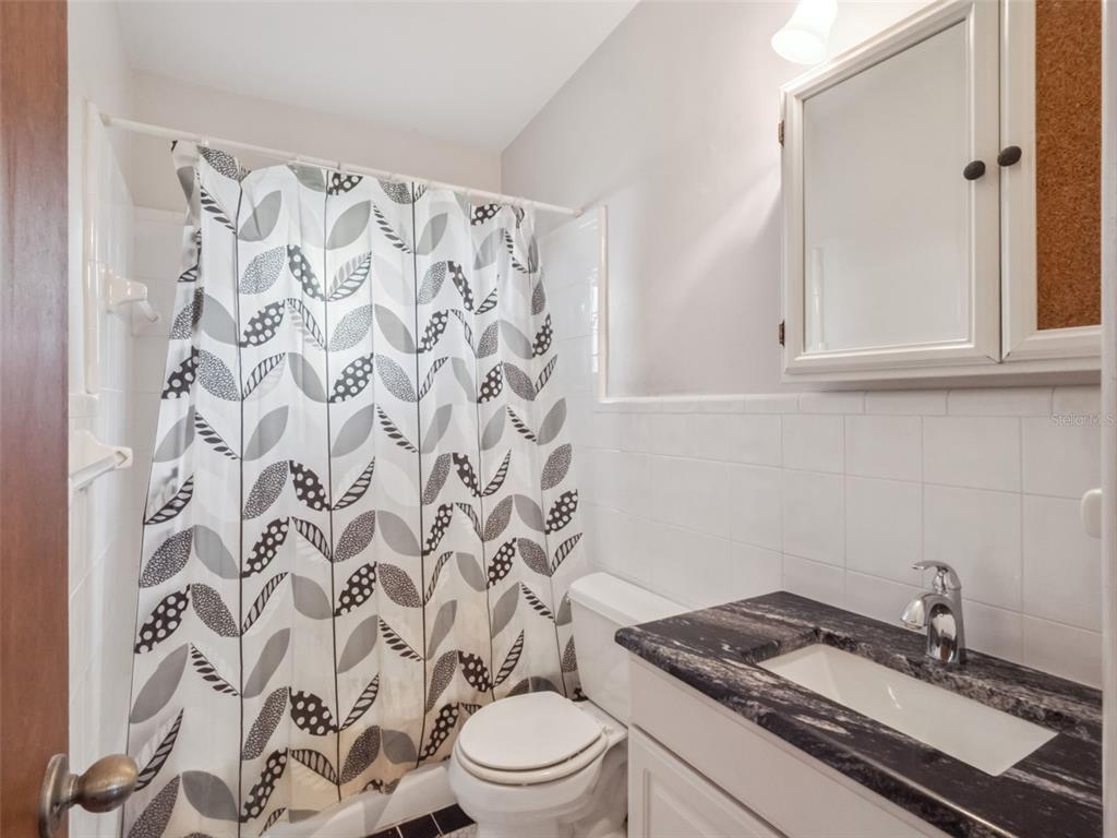 2819 Rogan Road Orlando, FL 32812 - Photo 18 of 28 a bathroom with a granite countertop sink and a toilet