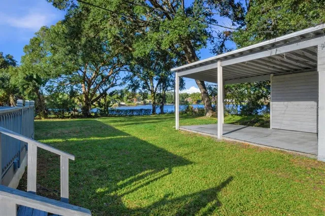 a view of a house with backyard and porch